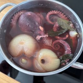 Cooking octopus in a pot of stock.