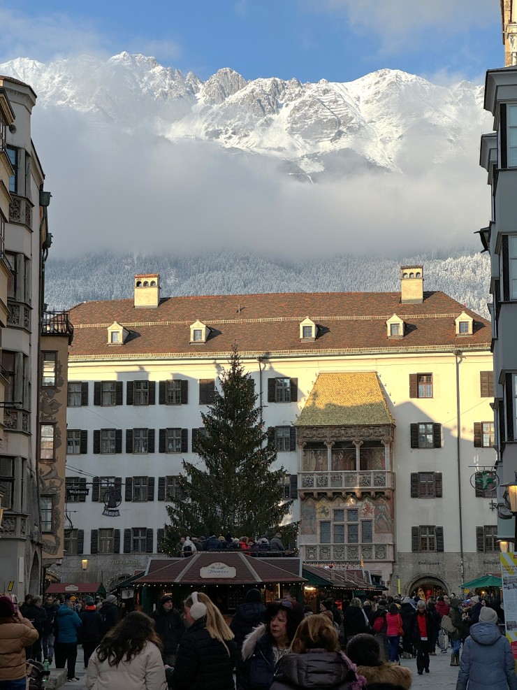 Austrian Alps towering over the golden roof in Innsbruck, Austria