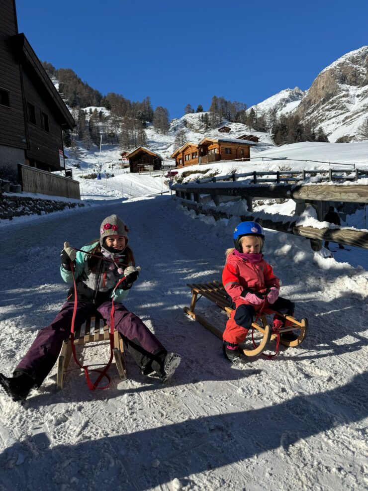 The kids with their toboggans ready to sled from the Furi gondola in Zermatt Switzerland