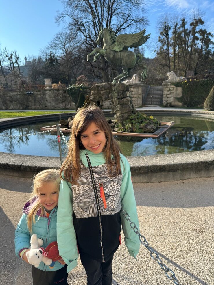 Winter family fun in Salzburg, Austria visiting the Pegasus fountain within Mirabell Gardens, a Sound of Music scene location