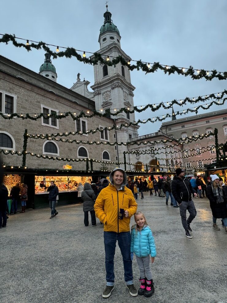 Winter family fun in Salzburg trying the Gluhwein at the Residenzplatz Christmas market in Salzburg, Austria