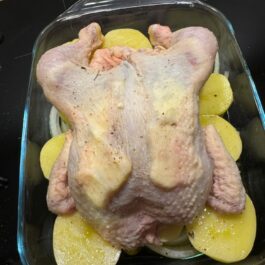 Preparing roast chicken with butter under the skin