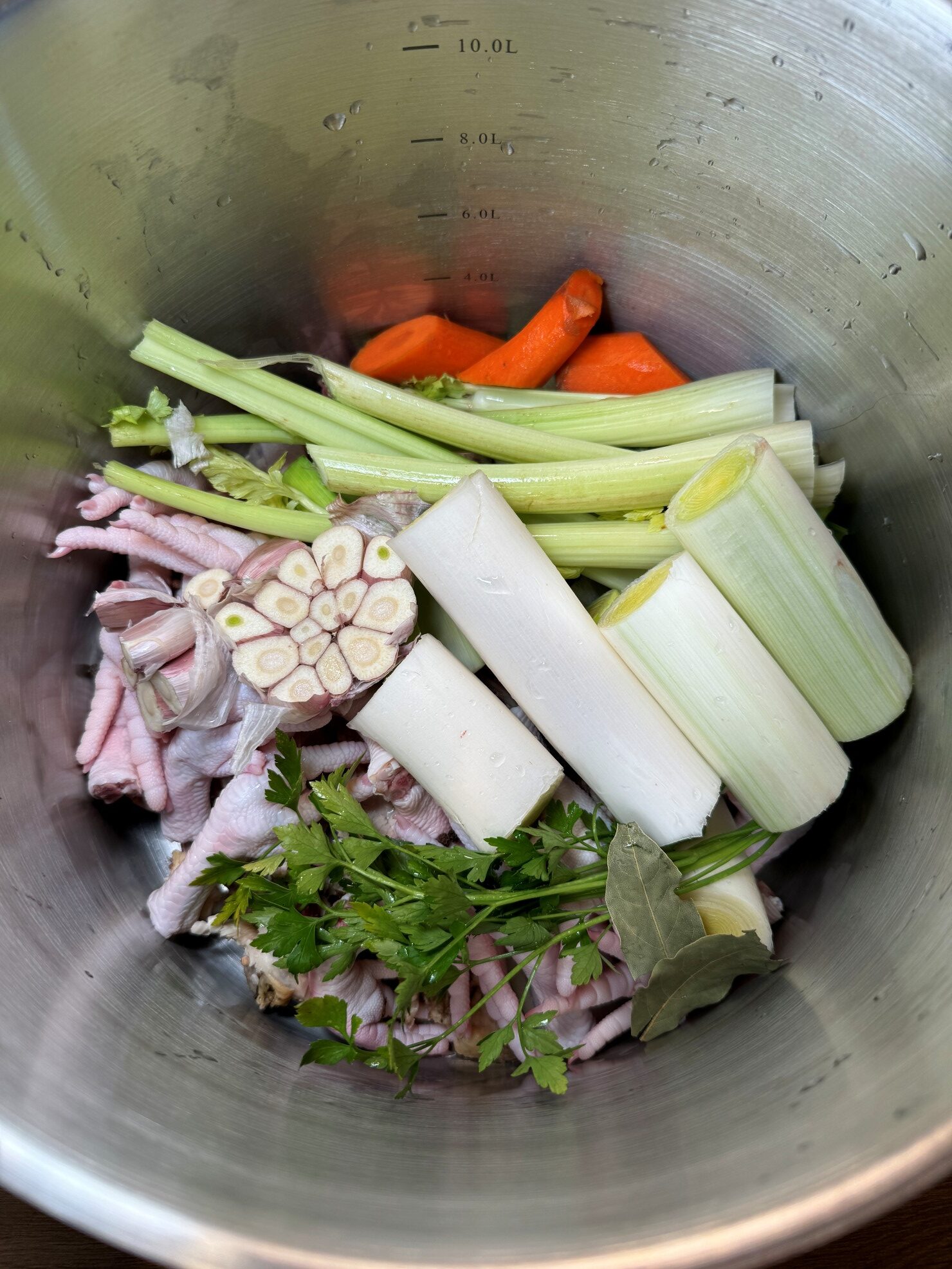 Ingredients in a pot with the herbs for the ultimate homemade chicken stock