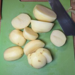 Cutting potatoes in half before boiling for Tortilla Espanola