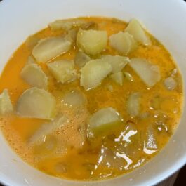 Mixing potatoes, onions, and eggs for Tortilla Espanola