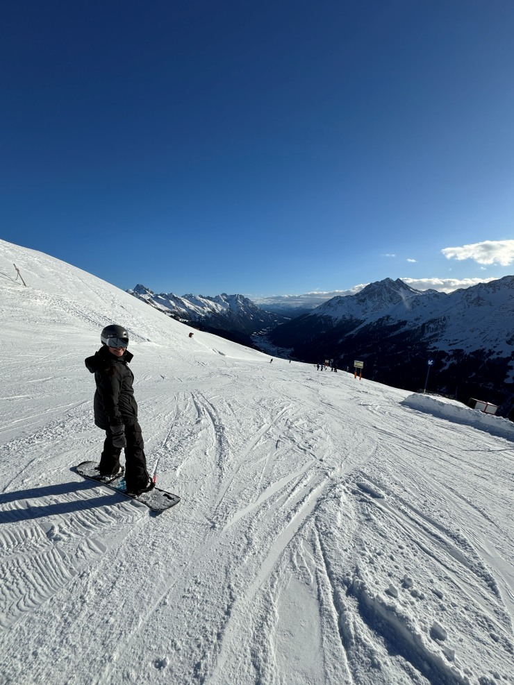 Snowboarding and taking in the vistas of the valley from the slopes of Kapall at St. Anton ski resort in Austria