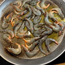 Cooking shrimp for Authentic Paella: Shrimp and Pork "Secreto" Steak