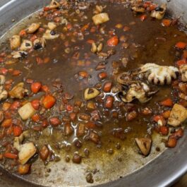 Cooking the base for a sofrito for Authentic Paella: Shrimp and Pork "Secreto" Steak