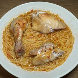 Spanish chicken noodle stew plated with Roast chicken and Fideo noodles and Fideo noodles, Sopa de Pollo con Fideos